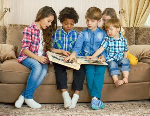 Kids looking at a scrapbook or photo album