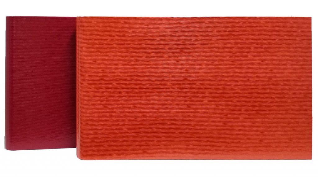 Tabloid 3-Ring Binders in Red and Orange. 